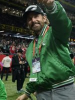 Man-in-green-jacket-with-Super-Bowl-lanyard-at-sports-event